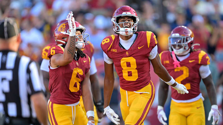 Oct 11, 2025; Los Angeles, California, USA;  USC Trojans wide receiver Ja'Kobi Lane (8) is congratulated by wide receiver Makai Lemon (6) after catching a touchdown pass in the first half at United Airlines Field at the Los Angeles Memorial Coliseum. Mandatory Credit: Jayne Kamin-Oncea-Imagn Images
