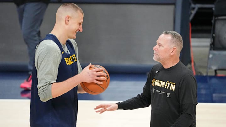 May 31, 2023; Denver, CO, USA; Denver Nuggets center Nikola Jokic (15) talks with head coach Michael Malone during a practice session on media day before the 2023 NBA Finals at Ball Arena. Mandatory Credit: Kyle Terada-Imagn Images