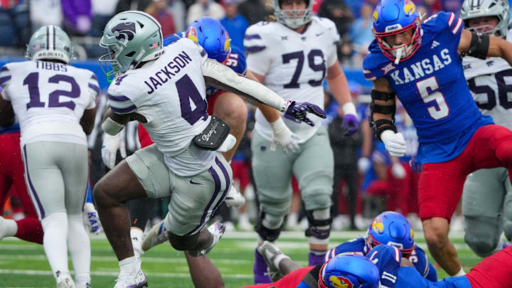 Kansas State Wildcats running back Joe Jackson and Kansas Jayhawks defensive back DJ Graham II 