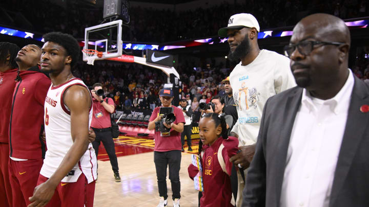 Dec 10, 2023; Los Angeles, California, USA; LeBron James was to his curtsied seats as his son USC Trojans guard Bronny James (6) sands with teammates before the start of a game against the Long Beach State 49ers at Galen Center. Mandatory Credit: Robert Hanashiro-USA TODAY Sports