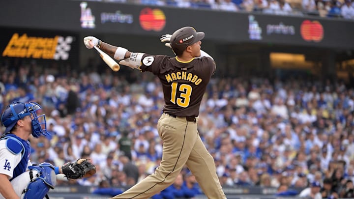 Oct 11, 2024; Los Angeles, California, USA; San Diego Padres third baseman Manny Machado (13) flies out in the second inning against the Los Angeles Dodgers during game five of the NLDS for the 2024 MLB Playoffs at Dodger Stadium. Mandatory Credit: Jayne Kamin-Oncea-Imagn Images