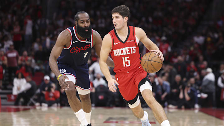 Dec 11, 2025; Houston, Texas, USA; Houston Rockets guard Reed Sheppard (15) dribbles the ball as Los Angeles Clippers guard James Harden (1) defends during the fourth quarter at Toyota Center. Mandatory Credit: Troy Taormina-Imagn Images