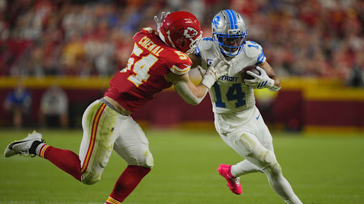 Oct 12, 2025; Kansas City, Missouri, USA; Detroit Lions wide receiver Amon-Ra St. Brown (14) makes a catch over Kansas City Chiefs linebacker Leo Chenal (54) during the first half at GEHA Field at Arrowhead Stadium. Mandatory Credit: Jay Biggerstaff-Imagn Images