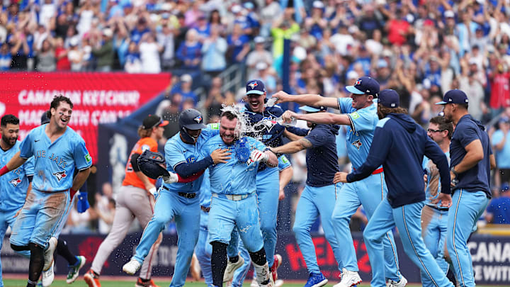 Sep 13, 2025; Toronto, Ontario, CAN; Toronto Blue Jays catcher Alejandro Kirk (30) is swarmed by his teammates after sacrificing in the winning run against the Baltimore Orioles at the end of the ninth inning at Rogers Centre. Mandatory Credit: Nick Turchiaro-Imagn Images Sep 13, 2025; Toronto, Ontario, CAN; Toronto Blue Jays catcher Alejandro Kirk (30) is swarmed by his teammates after sacrificing in the winning run against the Baltimore Orioles at the end of the ninth inning at Rogers Centre. Mandatory Credit: Nick Turchiaro-Imagn Images