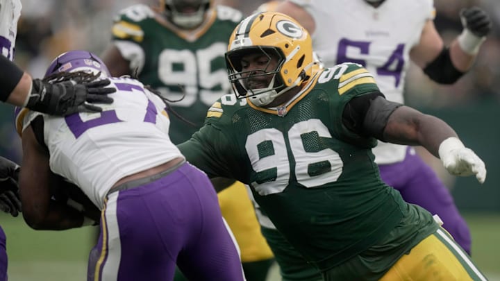 Green Bay Packers defensive tackle Colby Wooden (96) stuffs Minnesota Vikings running back Jordan Mason.