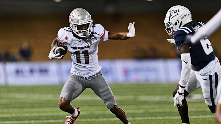 UNLV Rebels wide receiver Ricky White III (11) runs with the ball against the Utah State Aggies at Merlin Olsen Field at Maverik Stadium. UNLV Rebels wide receiver Ricky White III (11) runs with the ball against the Utah State Aggies at Merlin Olsen Field at Maverik Stadium.