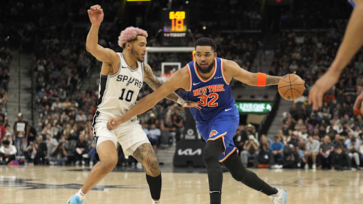 Mar 19, 2025; San Antonio, Texas, USA; New York Knicks forward Karl-Anthony Towns (32) drives to the basket while defended by San Antonio Spurs forward Jeremy Sochan (10) during the second half at Frost Bank Center. Mandatory Credit: Scott Wachter-Imagn Images