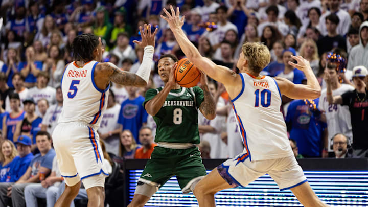 Nov 7, 2024; Gainesville, Florida, USA; Florida Gators guard Will Richard (5) and forward Thomas Haugh (10) defend Jacksonville Dolphins guard Jakari Spence (8) during the first half at Exactech Arena at the Stephen C. O'Connell Center. Mandatory Credit: Matt Pendleton-Imagn Images Nov 7, 2024; Gainesville, Florida, USA; Florida Gators guard Will Richard (5) and forward Thomas Haugh (10) defend Jacksonville Dolphins guard Jakari Spence (8) during the first half at Exactech Arena at the Stephen C. O'Connell Center. Mandatory Credit: Matt Pendleton-Imagn Images