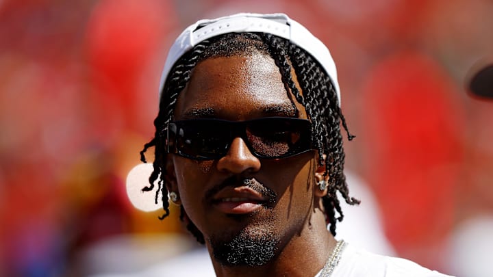 Washington Commanders quarterback Jayden Daniels looks on from the sidelines during the game against the Baltimore Ravens.