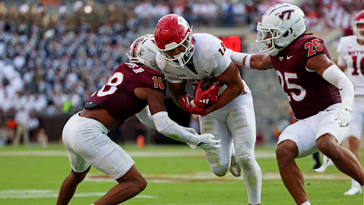 Sep 21, 2024; Blacksburg, Virginia, USA; Rutgers Scarlet Knights tight end Kenny Fletcher (12) runs for the end zone against Virginia Tech Hokies linebacker Caleb Woodson (25) and safety Mose Phillips III (18) during the third quarter at Lane Stadium. Mandatory Credit: Peter Casey-Imagn Images