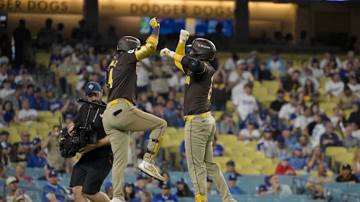 Oct 6, 2024; Los Angeles, California, USA; San Diego Padres catcher Kyle Higashioka (20) celebrates with first baseman Luis Arraez (4) after hitting a solo home run in the ninth inning against the Los Angeles Dodgers during game two of the NLDS for the 2024 MLB Playoffs at Dodger Stadium. Mandatory Credit: Jayne Kamin-Oncea-Imagn Images