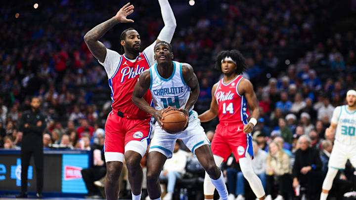 Dec 20, 2024; Philadelphia, Pennsylvania, USA; Charlotte Hornets forward Moussa Diabate (14) drives to shoot against Philadelphia 76ers center Andre Drummond (5) in the first quarter at Wells Fargo Center. Mandatory Credit: Kyle Ross-Imagn Images
