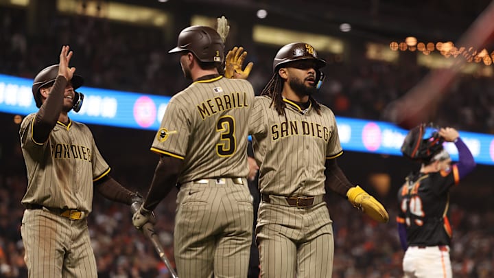 Jun 3, 2025; San Francisco, California, USA;  San Diego Padres left fielder Brandon Lockridge (28) and right fielder Fernando Tatis Jr. (23) high five on deck batter center fielder Jackson Merrill (3) after being batted in against the San Francisco Giants during the ninth inning at Oracle Park. Mandatory Credit: Kelley L Cox-Imagn Images