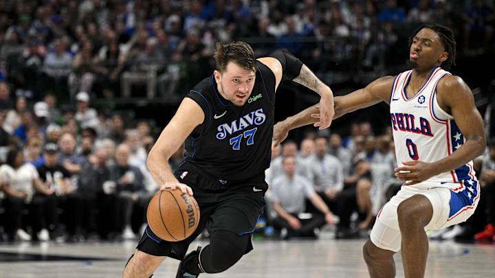 Mar 3, 2024; Dallas, Texas, USA; Dallas Mavericks guard Luka Doncic (77) moves the ball past Philadelphia 76ers guard Tyrese Maxey (0) during the second half at the American Airlines Center. Mandatory Credit: Jerome Miron-Imagn Images