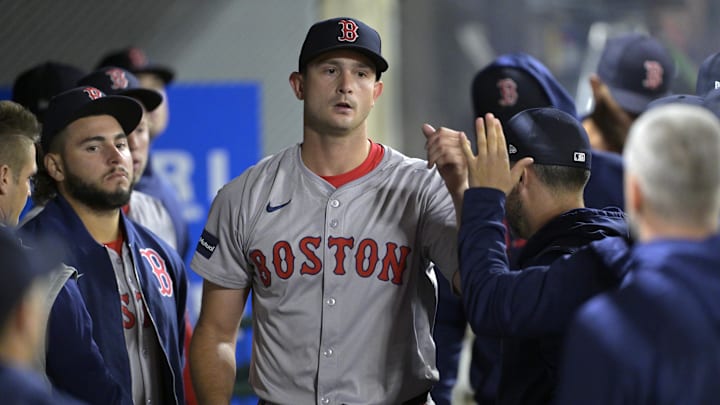 Boston Red Sox pitcher Garrett Whitlock (22) gets high fives in the dugout after he was taken out of the game in the fifth inning against the Los Angeles Angels at Angel Stadium in 2024.
