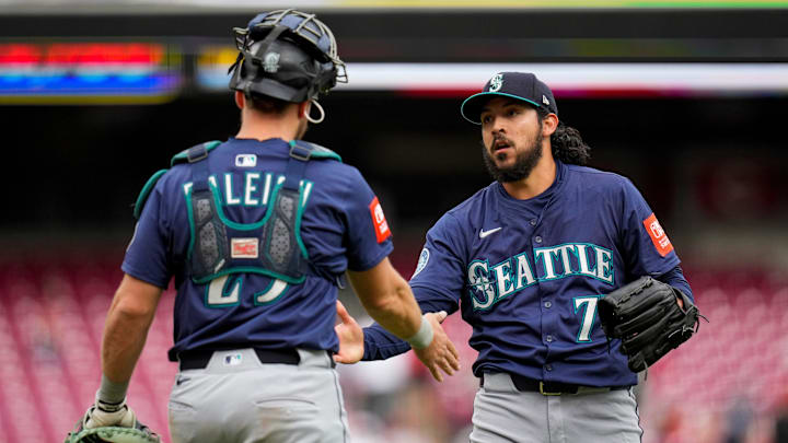 Seattle Mariners catcher Cal Raleigh (left) and pitcher Andrés Muñoz meet on the mound after a game against the Cincinnati Reds on April 17 at T-Mobile Park.
