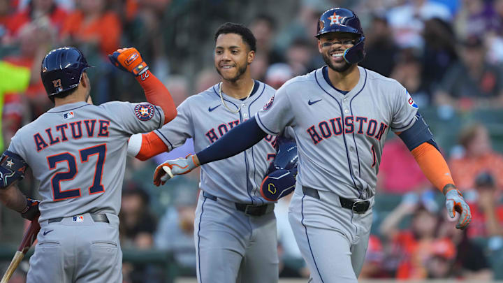 Houston Astros third baseman Carlos Correa (1) is greeted by designated hitter Jose Altuve (27) and shortstop Jeremy Pena (3) following his two-run home run. 