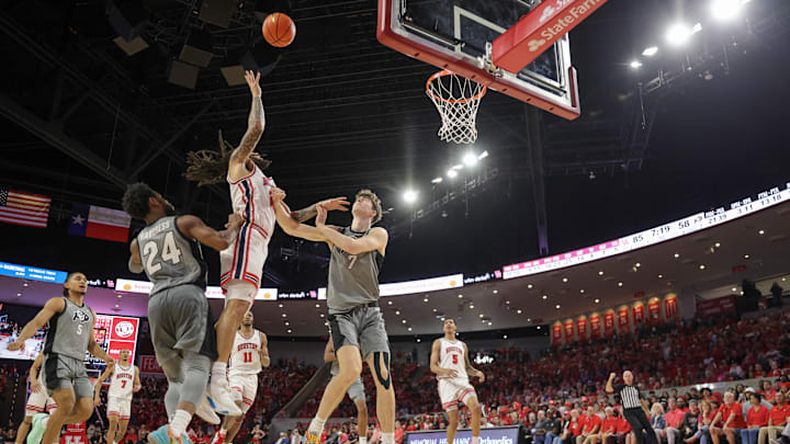 Feb 28, 2026; Houston, Texas, USA;  Houston Cougars guard Emanuel Sharp (21) shoots against Colorado Buffaloes forward Sebastian Rancik (7) in the second  half at Fertitta Center. Mandatory Credit: Thomas Shea-Imagn Images