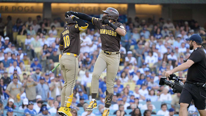 Oct 6, 2024; Los Angeles, California, USA; San Diego Padres outfielder Fernando Tatis Jr. (23) celebrates with outfielder Jurickson Profar (10) after hitting a solo home run in the first inning against the Los Angeles Dodgers during game two of the NLDS for the 2024 MLB Playoffs at Dodger Stadium. Mandatory Credit: Jayne Kamin-Oncea-Imagn Images