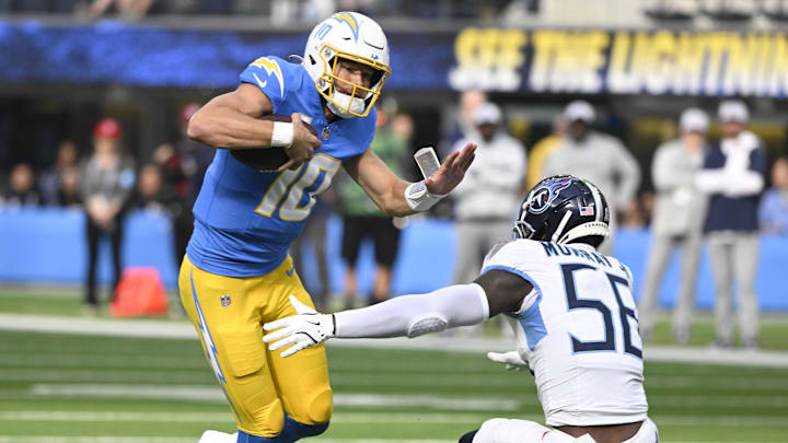 Nov 10, 2024; Inglewood, California, USA; Los Angeles Chargers quarterback Justin Herbert (10) tried to get past Tennessee Titans linebacker Kenneth Murray Jr. (56) during the first quarter at SoFi Stadium. Mandatory Credit: Robert Hanashiro-Imagn Images