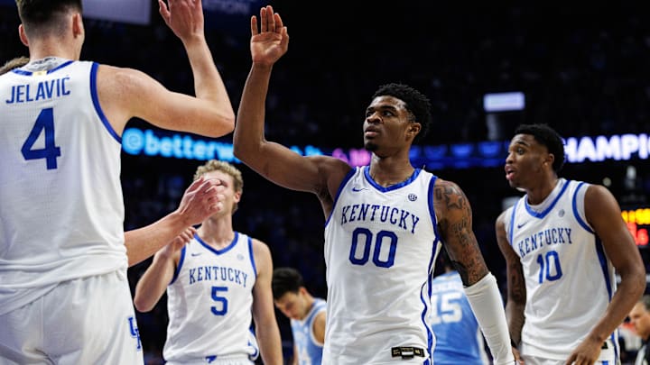 Dec 2, 2025; Lexington, Kentucky, USA; Kentucky Wildcats guard Otega Oweh (00) fives forward Andrija Jelavic (4) during the second half against the North Carolina Tar Heels at Rupp Arena at Central Bank Center. Mandatory Credit: Jordan Prather-Imagn Images