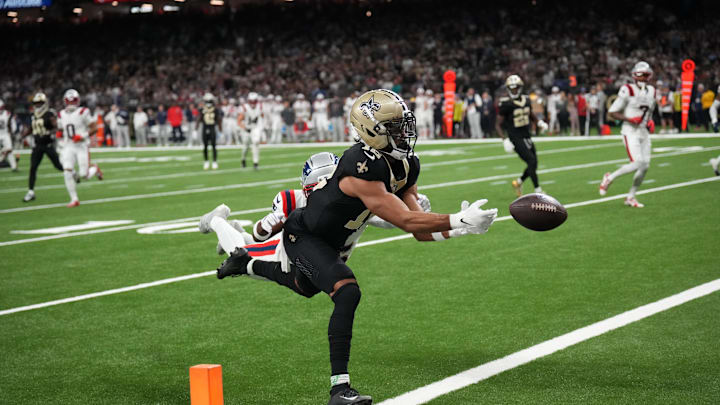 Oct 12, 2025; New Orleans, Louisiana, USA; New Orleans Saints wide receiver Chris Olave (12) misses a touchdown pass under pressure from New England Patriots cornerback Marcus Jones (25) during the second quarter at Caesars Superdome. Mandatory Credit: Matthew Hinton-Imagn Images