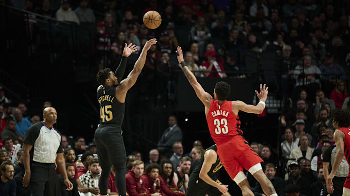 Nov 15, 2023; Portland, Oregon, USA; Cleveland Cavaliers guard Donovan Mitchell (45) shoots a basket during the first half against Portland Trail Blazers forward Toumani Camara (33) at Moda Center. Mandatory Credit: Troy Wayrynen-Imagn Images