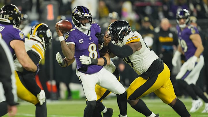 Jan 11, 2025; Baltimore, Maryland, USA; Pittsburgh Steelers defensive tackle Larry Ogunjobi (99) and linebacker Alex Highsmith (56) tackle Baltimore Ravens quarterback Lamar Jackson (8) in the third quarter in an AFC wild card game Jan 11, 2025; Baltimore, Maryland, USA; Pittsburgh Steelers defensive tackle Larry Ogunjobi (99) and linebacker Alex Highsmith (56) tackle Baltimore Ravens quarterback Lamar Jackson (8) in the third quarter in an AFC wild card game