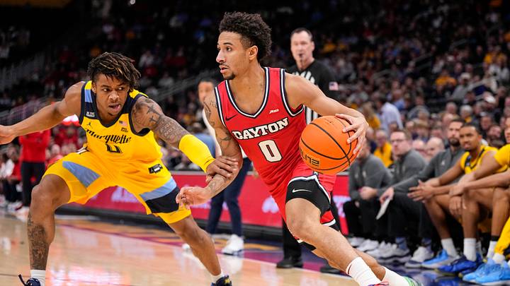 Nov 19, 2025; Milwaukee, Wisconsin, USA; Dayton Flyers guard Javon Bennett (0) drives for the basket against Marquette Golden Eagles guard Nigel James Jr. (0) during the first half at Fiserv Forum. Nov 19, 2025; Milwaukee, Wisconsin, USA; Dayton Flyers guard Javon Bennett (0) drives for the basket against Marquette Golden Eagles guard Nigel James Jr. (0) during the first half at Fiserv Forum.