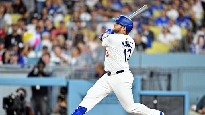 Aug 5, 2025; Los Angeles, California, USA; Los Angeles Dodgers third baseman Max Muncy (13) hits a two run home run during the third inning against the St. Louis Cardinals at Dodger Stadium. Mandatory Credit: William Liang-Imagn Images
