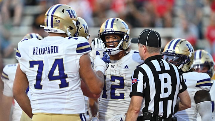 Denzel Boston (12) and Drew Azzopardi (74) celebrate Boston's touchdown catch at Maryland. 
