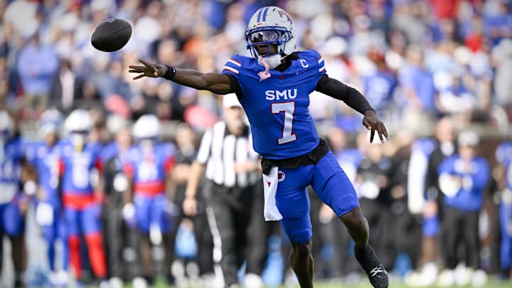 Nov 22, 2025; Dallas, Texas, USA; SMU Mustangs quarterback Kevin Jennings (7) throws a shovel pass to running back T.J. Harden (not pictured) for a touchdown against the Louisville Cardinals during the first half at Gerald J. Ford Stadium. Mandatory Credit: Jerome Miron-Imagn Images