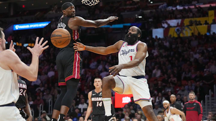 Mar 12, 2025; Miami, Florida, USA;  LA Clippers guard James Harden (1) passes the ball around Miami Heat center Bam Adebayo (13) during the first half at Kaseya Center. Mandatory Credit: Jim Rassol-Imagn Images