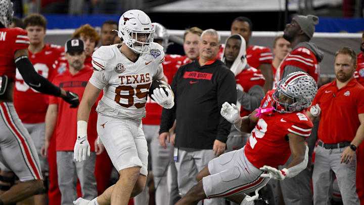 Jan 10, 2025; Arlington, TX, USA; Texas Longhorns tight end Gunnar Helm (85) shoves Ohio State Buckeyes safety Caleb Downs (2) and draws a penalty during the game between the Texas Longhorns and the Ohio State Buckeyes at AT&T Stadium. Mandatory Credit: Jerome Miron-Imagn Images