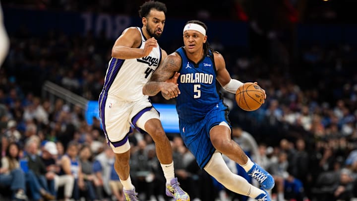 Mar 29, 2025; Orlando, Florida, USA; Orlando Magic forward Paolo Banchero (5) dribbles past Sacramento Kings forward Trey Lyles (41) in the fourth quarter at Kia Center. Mandatory Credit: Jeremy Reper-Imagn Images Mar 29, 2025; Orlando, Florida, USA; Orlando Magic forward Paolo Banchero (5) dribbles past Sacramento Kings forward Trey Lyles (41) in the fourth quarter at Kia Center. Mandatory Credit: Jeremy Reper-Imagn Images