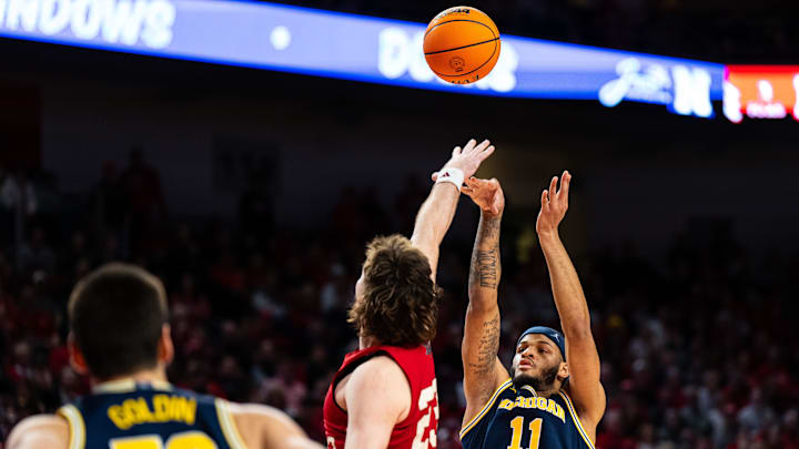 Feb 24, 2025; Lincoln, Nebraska, USA; Michigan Wolverines guard Roddy Gayle Jr. (11) shoots the ball against Nebraska Cornhuskers forward Andrew Morgan (23) during the second half at Pinnacle Bank Arena. Mandatory Credit: Dylan Widger-Imagn Images