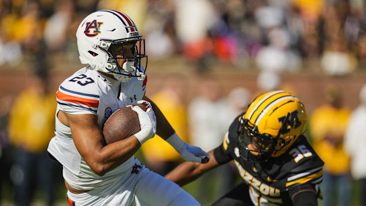 Oct 19, 2024; Columbia, Missouri, USA; Auburn Tigers running back Jeremiah Cobb (23) returns a kickoff against Missouri Tigers safety Caleb Flagg (36) during the first half at Faurot Field at Memorial Stadium. Mandatory Credit: Jay Biggerstaff-Imagn Images