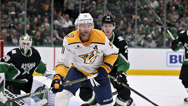Feb 28, 2026; Dallas, Texas, USA; Nashville Predators center Steven Stamkos (91) and Dallas Stars defenseman Esa Lindell (23) chase the puck during the third period at the American Airlines Center. Mandatory Credit: Jerome Miron-Imagn Images