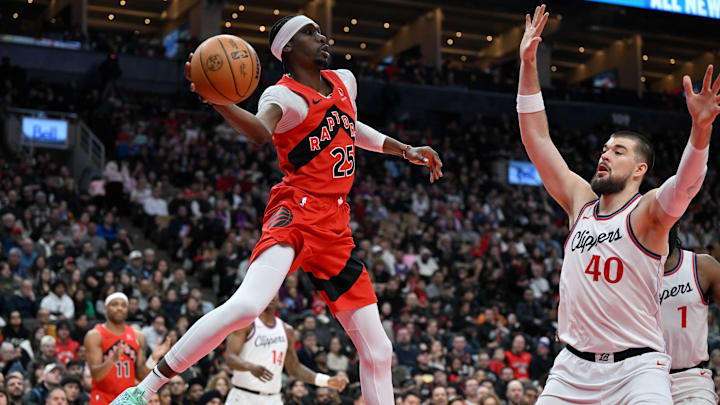 Feb 2, 2025; Toronto, Ontario, CAN; Toronto Raptors forward Chris Boucher (25) passes the ball over Los Angeles Clippers center Ivica Zubac (40) in the first half at Scotiabank Arena. Mandatory Credit: Dan Hamilton-Imagn Images Feb 2, 2025; Toronto, Ontario, CAN; Toronto Raptors forward Chris Boucher (25) passes the ball over Los Angeles Clippers center Ivica Zubac (40) in the first half at Scotiabank Arena. Mandatory Credit: Dan Hamilton-Imagn Images