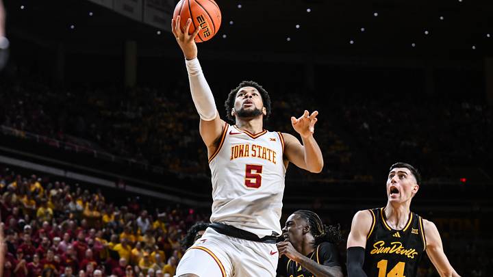 Mar 7, 2026; Ames, Iowa, USA; Iowa State Cyclones forward Joshua Jefferson (5) goes to the basket as Arizona State Sun Devils forward Andrija Grbovic (14) defends during the first half at James H. Hilton Coliseum. Mandatory Credit: Jeffrey Becker-Imagn Images