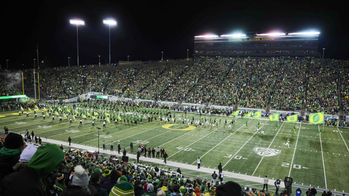 Nov 24, 2023; Eugene, Oregon, USA; Oregon Ducks fans cheer as the Ducks football team take the field before a game against the Oregon State Beavers at Autzen Stadium. Mandatory Credit: Troy Wayrynen-USA TODAY Sports Nov 24, 2023; Eugene, Oregon, USA; Oregon Ducks fans cheer as the Ducks football team take the field before a game against the Oregon State Beavers at Autzen Stadium. Mandatory Credit: Troy Wayrynen-USA TODAY Sports