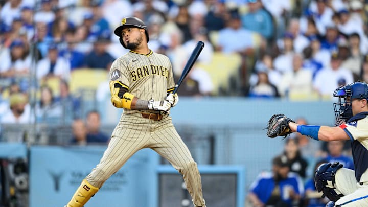 Aug 16, 2025; Los Angeles, California, USA; San Diego Padres first baseman Luis Arraez (4) reacts after a pitch during the fourth inning against the Los Angeles Dodgers at Dodger Stadium. Mandatory Credit: William Liang-Imagn Images
