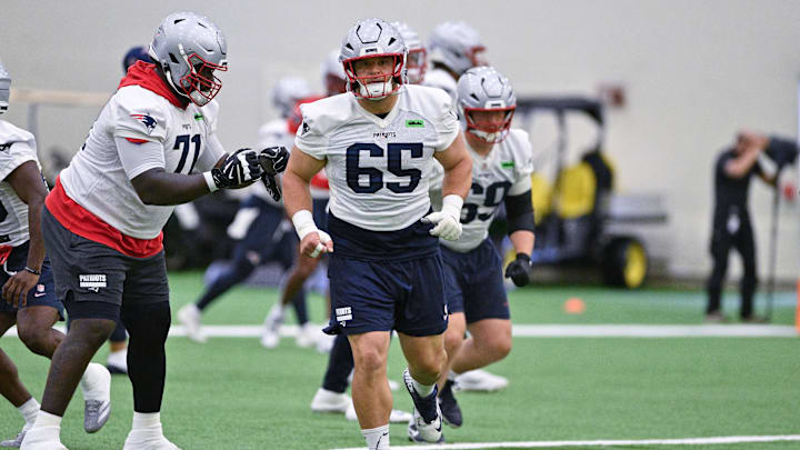 Jun 10, 2025; Foxborough, MA, USA; New England Patriots center Garrett Bradbury (65) does a drill during minicamp held in the WIN Field House at Gillette Stadium. Mandatory Credit: Eric Canha-Imagn Images