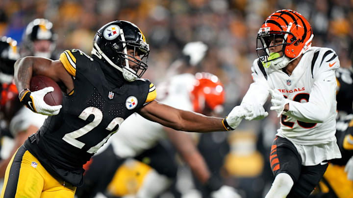 Pittsburgh Steelers running back Najee Harris (22) carries the ball as Cincinnati Bengals cornerback DJ Turner II (20) defends in the third quarter during a Week 16 NFL football game between the Cincinnati Bengals and the Pittsburgh Steelersl, Saturday, Dec. 23, 2023, at Acrisure Stadium in Pittsburgh, Pa.