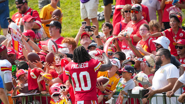Jul 26, 2024; Kansas City, MO, USA; Kansas City Chiefs running back Isiah Pacheco (10) signs autographs for fans after training camp at Missouri Western State University. Mandatory Credit: Denny Medley-Imagn Images