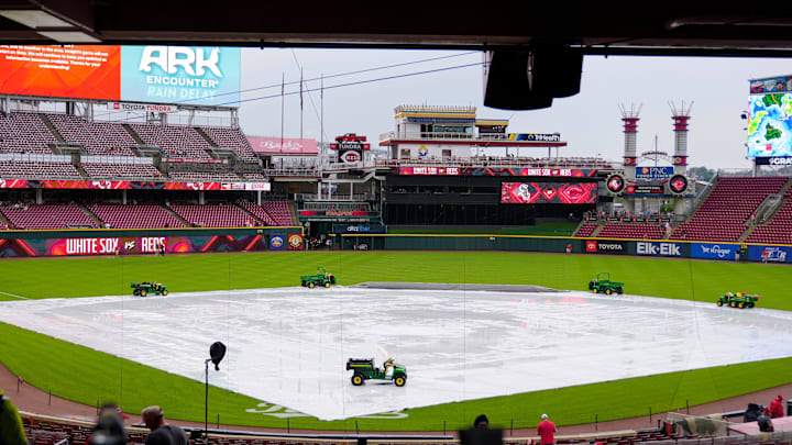 The tarp covers the infield during a rain delay before the MLB interleague game between the Cincinnati Reds and the Chicago White Sox at Great American Ball Park in Cincinnati on Tuesday, May 13, 2025.