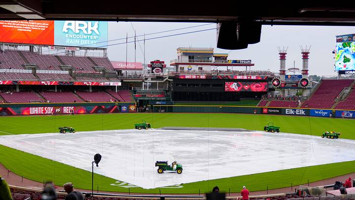 The tarp covers the infield during a rain delay before the MLB interleague game between the Cincinnati Reds and the Chicago White Sox at Great American Ball Park in Cincinnati on Tuesday, May 13, 2025. The tarp covers the infield during a rain delay before the MLB interleague game between the Cincinnati Reds and the Chicago White Sox at Great American Ball Park in Cincinnati on Tuesday, May 13, 2025.