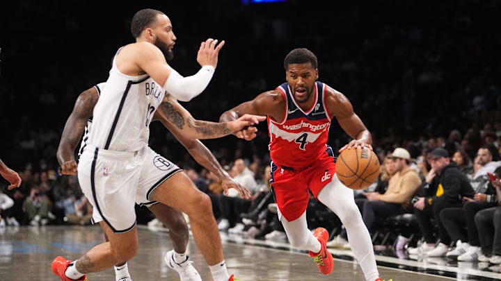 Oct 14, 2024; Brooklyn, New York, USA; Washington Wizards shooting guard Jared Butler (4) dribbles the ball against Brooklyn Nets point guard Ben Simmons (10) during the second half at Barclays Center. Mandatory Credit: Gregory Fisher-Imagn Images