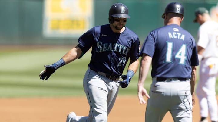 Seattle Mariners catcher Cal Raleigh (29) gets a congratulatory handshake from third base coach Manny Acta (14) after hitting a two-run home run against the Oakland Athletics during the first inning at Oakland-Alameda County Coliseum on Sept 5.
