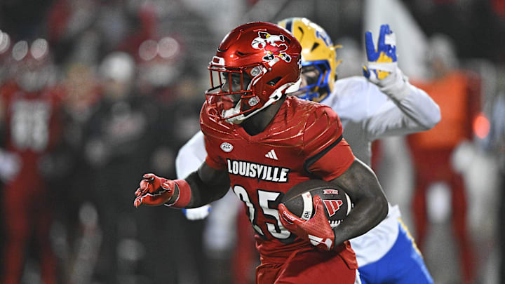 Nov 23, 2024; Louisville, Kentucky, USA;  Louisville Cardinals running back Isaac Brown (25) runs against the Pittsburgh Panthers during the second half at L&N Federal Credit Union Stadium. Louisville defeated Pittsburgh 37-9.